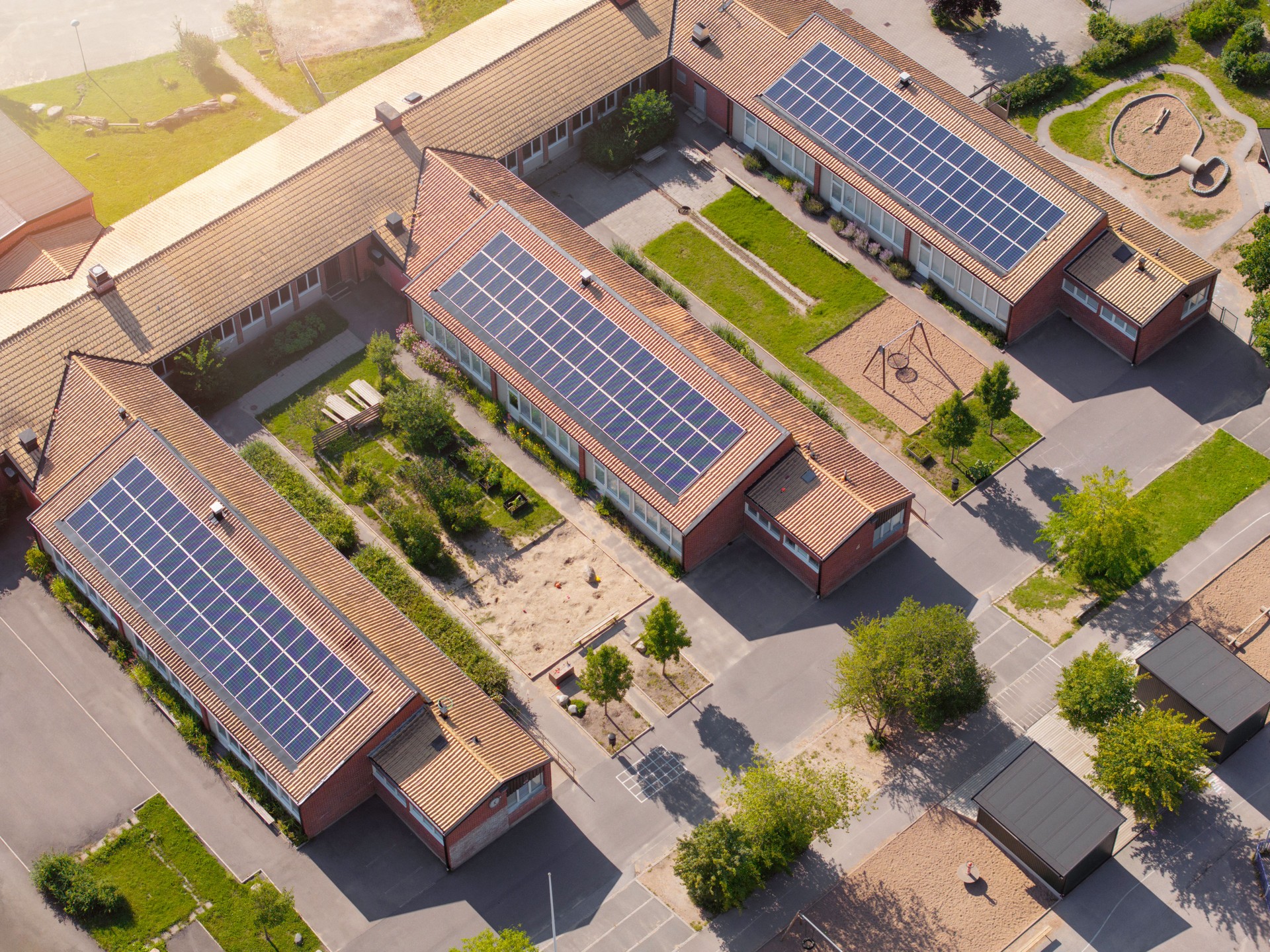 Aerial view of a school building with solar power on the roof